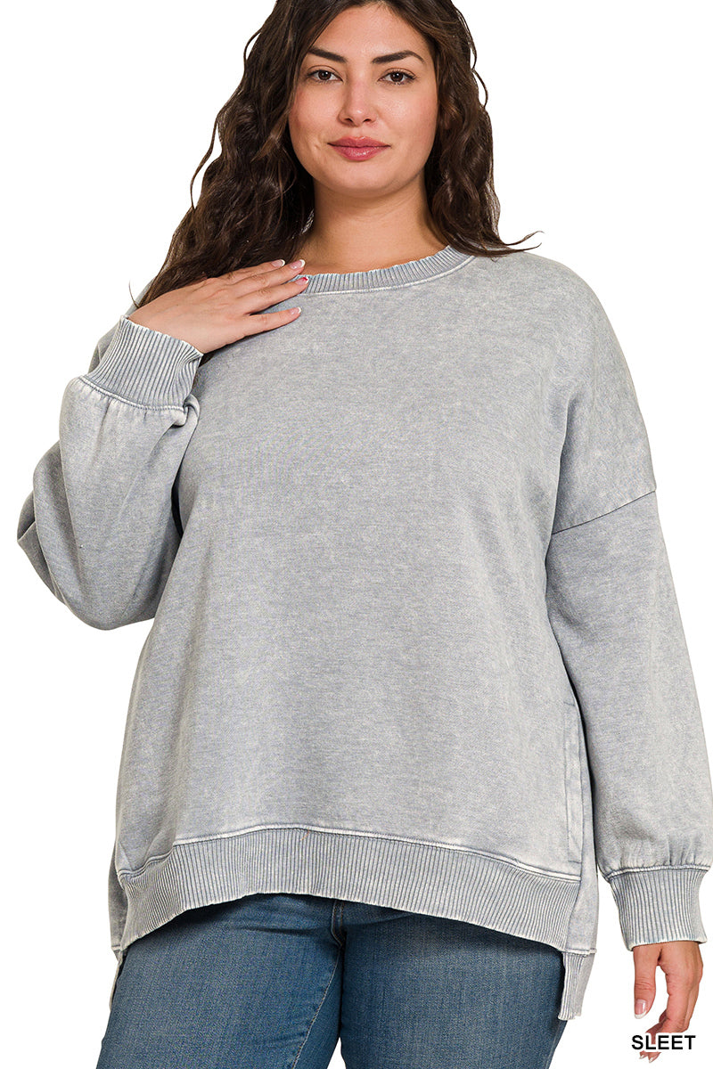 Woman wearing a gray sweatshirt with a plain background
